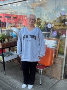 Mandy, who was diagnosed with Parkinson’s in 2020, stands in front of a store front