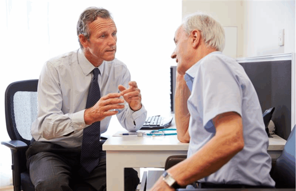Health care professional talking to a Parkinson's patient