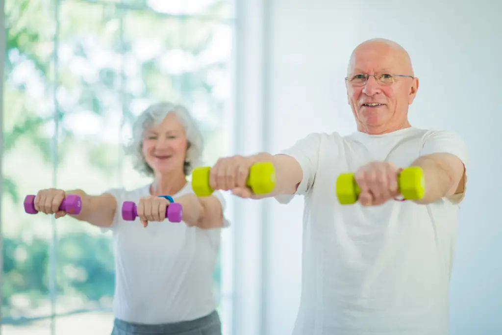 A middle-aged man and woman exercising with dumbbells