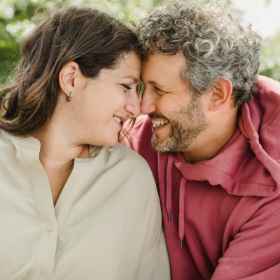 A couple whose face are close to each other almost kissing