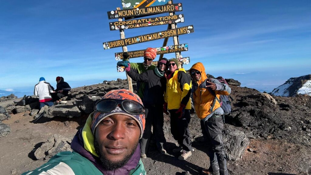 Gaby, Marcel, and their guides at the top of Mountt Kilimanjaro