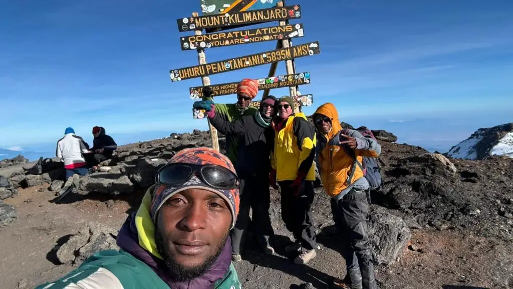Gaby, Marcel, and their guides at the top of Mountt Kilimanjaro