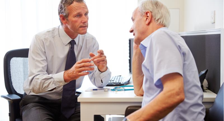 Health care professional talking to a Parkinson's patient