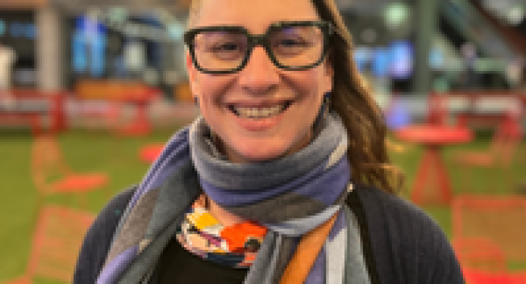 Abby, woman living with PSP, smiles to the camera