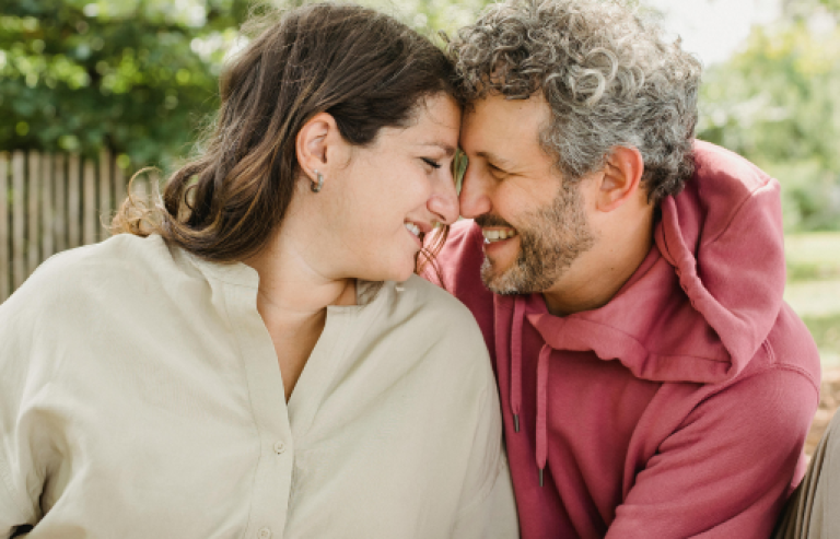 A couple whose face are close to each other almost kissing