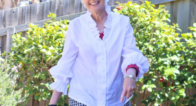 Wendy joyfully walking through a manicured garden in her backyard